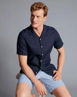 CHARLES TYRWHITT Revere Collar Pure Linen Short Sleeve Shirt - Navy B -Charles Tyrwhitt Shop CSR2068NAV MODEL SEATED